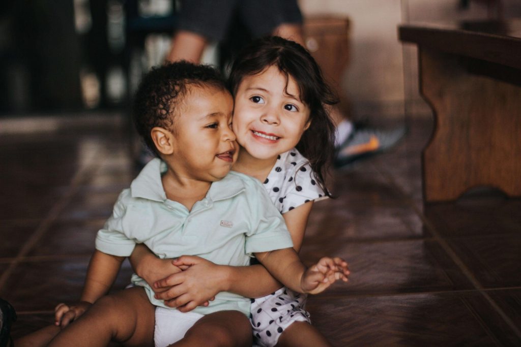 two small children smiling and hugging