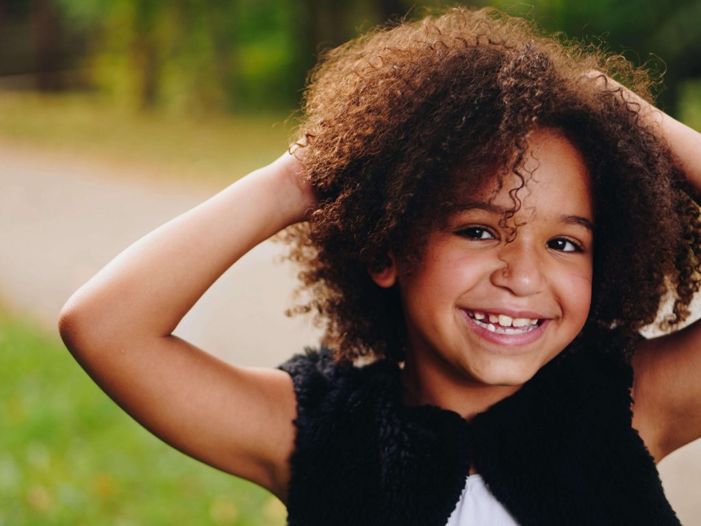 smiling child with curly dark hair